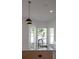 Close up view of island sink with marble countertops, light wood cabinets, and black pendant lights at 7646 Coconut Creek Ct, Orlando, FL 32822