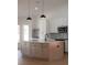 Kitchen island features a marble countertop, light wood cabinets, a black faucet, and stainless steel appliances at 7646 Coconut Creek Ct, Orlando, FL 32822