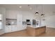 Spacious kitchen features a center island, stainless steel appliances, and hardwood floors at 7646 Coconut Creek Ct, Orlando, FL 32822