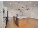 Modern kitchen features a center island, stainless steel appliances, and hardwood floors at 7646 Coconut Creek Ct, Orlando, FL 32822