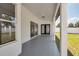 Covered back patio with sliding glass doors and views of the backyard at 7646 Coconut Creek Ct, Orlando, FL 32822