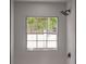 Shower with glass enclosure and a window offering natural light and backyard views at 7646 Coconut Creek Ct, Orlando, FL 32822