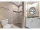 Bathroom featuring a tiled shower, vanity with sink, decorative mirror, and a toilet at 8 Water Trce, Ocala, FL 34472