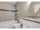 A bathroom with granite sink, white cabinets and tiled shower with tub at 8 Water Trce, Ocala, FL 34472