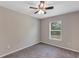 This bedroom has gray carpet, neutral-colored walls, ceiling fan and a window at 8 Water Trce, Ocala, FL 34472