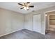 This bedroom has gray carpet, neutral-colored walls, ceiling fan and a closet at 8 Water Trce, Ocala, FL 34472