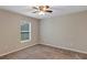 Bedroom with neutral paint, carpet flooring, a ceiling fan, and window providing natural light at 8 Water Trce, Ocala, FL 34472