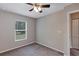 This bedroom has gray carpet, neutral-colored walls, ceiling fan and a window at 8 Water Trce, Ocala, FL 34472