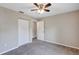This bedroom has gray carpet, neutral-colored walls, ceiling fan and a closet at 8 Water Trce, Ocala, FL 34472