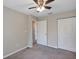 This bedroom has gray carpet, neutral-colored walls, ceiling fan and a closet at 8 Water Trce, Ocala, FL 34472