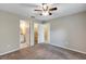 Bedroom features carpet flooring, neutral paint, ceiling fan, and access to bathroom and closet space at 8 Water Trce, Ocala, FL 34472