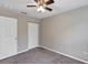 This bedroom has gray carpet, neutral-colored walls, ceiling fan and a closet at 8 Water Trce, Ocala, FL 34472