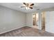 Bedroom featuring neutral paint, carpet flooring, a ceiling fan, and an entry to the bathroom at 8 Water Trce, Ocala, FL 34472