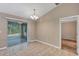 Dining area with tile floors, a chandelier, and sliding doors to the enclosed back patio at 8 Water Trce, Ocala, FL 34472