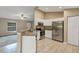 Bright kitchen with white cabinetry, stainless steel appliances, granite countertops, and tiled floors at 8 Water Trce, Ocala, FL 34472