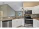 Open kitchen with granite countertops, stainless steel appliances, white cabinets, and tile flooring at 8 Water Trce, Ocala, FL 34472