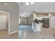 Open-concept living and kitchen area with tile and carpet flooring, stainless appliances and recessed lighting at 8 Water Trce, Ocala, FL 34472