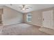 Open living room features neutral paint, carpet flooring, a front door, and a window with mini blinds at 8 Water Trce, Ocala, FL 34472