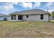 A wide lawn stretches to the back of this home with a screened patio at 8 Water Trce, Ocala, FL 34472