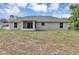 The back of this home features a screened in porch and a large green lawn at 8 Water Trce, Ocala, FL 34472