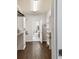 Walk-in closet with custom shelving and wood flooring, leads to bathroom at 811 Sherbourne Cir, Lake Mary, FL 32746