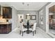 Bright dining area features modern decor, a pendant light, and a view to the laundry room at 811 Sherbourne Cir, Lake Mary, FL 32746