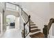 Elegant entryway with a staircase featuring dark wood and white trim, plus tile flooring at 811 Sherbourne Cir, Lake Mary, FL 32746