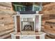 Stone fireplace with wood accents and TV, creating a cozy focal point in the living space at 811 Sherbourne Cir, Lake Mary, FL 32746
