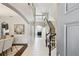 Elegant foyer with a soaring ceiling, staircase, and decorative wainscoting for a grand entrance at 811 Sherbourne Cir, Lake Mary, FL 32746