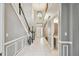 Inviting foyer features soaring ceilings, staircase, and half bathroom with stylish pedestal sink at 811 Sherbourne Cir, Lake Mary, FL 32746