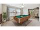 Game room with a pool table, ceiling fan, and natural light from the windows at 811 Sherbourne Cir, Lake Mary, FL 32746