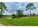Scenic view of golf course, pond, and lush green surroundings from the property at 811 Sherbourne Cir, Lake Mary, FL 32746