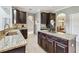 Gourmet kitchen featuring dark wood cabinets, granite countertops, and stainless steel sink at 811 Sherbourne Cir, Lake Mary, FL 32746