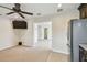 Open living area with a ceiling fan, television, and doorway leading to another room at 811 Sherbourne Cir, Lake Mary, FL 32746