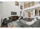 Spacious living room with soaring ceilings, modern decor, and a view to the second floor at 811 Sherbourne Cir, Lake Mary, FL 32746