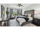 Serene main bedroom with bay windows, decorative rug, and a luxurious upholstered headboard at 811 Sherbourne Cir, Lake Mary, FL 32746