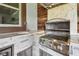 Close-up of an outdoor kitchen area featuring a stainless steel grill and stone countertop at 811 Sherbourne Cir, Lake Mary, FL 32746