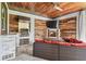 Outdoor kitchen with a built-in grill, sink, fireplace, and comfortable seating at 811 Sherbourne Cir, Lake Mary, FL 32746