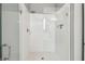 Modern shower featuring clear glass doors, white tile, and a chrome showerhead at 811 Sherbourne Cir, Lake Mary, FL 32746