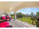 Balcony features comfortable seating, with views of manicured landscaping and a serene body of water at 1010 Juliette Blvd, Mount Dora, FL 32757