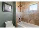 Bathroom showcasing a bathtub with tiled walls, shower head, with a toilet adjacent to the tub at 1010 Juliette Blvd, Mount Dora, FL 32757