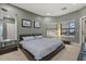 Bedroom features a low-profile bed frame, gray walls with artwork, and a large mirror creating a bright and airy atmosphere at 1010 Juliette Blvd, Mount Dora, FL 32757