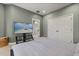 Bedroom boasts a spacious closet, a wall-mounted television, and neutral-toned walls providing a cozy and inviting atmosphere at 1010 Juliette Blvd, Mount Dora, FL 32757