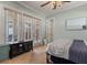 Relaxing bedroom featuring a comfortable bed, neutral tones, and a view of the outdoors at 1010 Juliette Blvd, Mount Dora, FL 32757