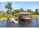 Exterior view of a dock with a jet ski and lounge chairs, perfect for lakeside enjoyment at 1010 Juliette Blvd, Mount Dora, FL 32757