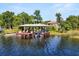 Wide lake view of boat dock with boat lift and boat at 1010 Juliette Blvd, Mount Dora, FL 32757