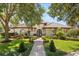 Charming home featuring a well manicured front yard, beautiful landscaping and a classic tile roof at 1010 Juliette Blvd, Mount Dora, FL 32757