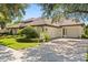Stunning home featuring a three car garage, pristine landscaping and a classic tile roof at 1010 Juliette Blvd, Mount Dora, FL 32757