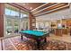 Game room features a pool table, high ceilings, and seamless transition to outdoor seating area, perfect for entertaining at 1010 Juliette Blvd, Mount Dora, FL 32757