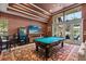Game room with pool table, high ceilings, large windows, and a cozy seating area, perfect for entertaining at 1010 Juliette Blvd, Mount Dora, FL 32757